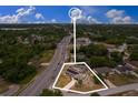 Aerial view of a property with a pool, solar panels, and a large lot near a bustling road at 1660 E Apache Cir, Deltona, FL 32725
