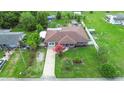 Aerial view of a quaint home with a spacious yard, mature trees, and inviting curb appeal at 1702 Palmetto Ave, Deland, FL 32724