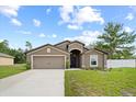 Lovely single-story home featuring a two-car garage, green lawn, and a partially fenced yard at 1846 N Acadian Dr, Deltona, FL 32725
