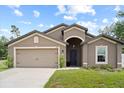 Attractive single-story home with a two-car garage, neat landscaping, and a classic design at 1846 N Acadian Dr, Deltona, FL 32725