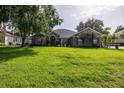 Well maintained single story home with a manicured front lawn and mature trees at 19232 Park Place Blvd, Eustis, FL 32736