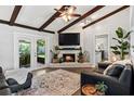 Inviting living room with exposed wood beams and a cozy brick fireplace at 204 Rio Pinar Dr, Ormond Beach, FL 32174