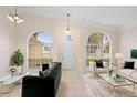 Bright living room showcasing large windows, tile flooring, and stylish furniture at 2263 Catbriar Way, Oviedo, FL 32765