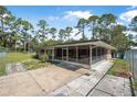 View of a screened-in porch with seating and an adjacent fenced yard at 2620 Doyle Rd, Deltona, FL 32738