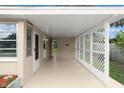This home features a spacious carport with latticework and a neutral color scheme at 2633 Yale Rd, South Daytona, FL 32119