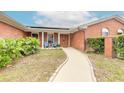 Inviting front entrance with a decorative wooden door, landscaping, and seating area at 2724 N Halifax Ave, Daytona Beach, FL 32118