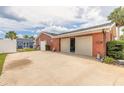Exterior garage showcases a large sliding garage door with convenient side entry and a storage shed at 2724 N Halifax Ave, Daytona Beach, FL 32118