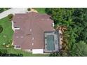 Aerial view showcases a beautiful pool, roof, and luscious landscaping at 3 Pine Meadow Ct, Debary, FL 32713