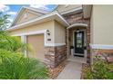 Inviting front entrance with stone accents and a covered porch at 31 Abacus Ave, Ormond Beach, FL 32174
