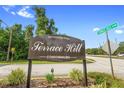 Terrace Hill Condominiums sign on a corner lot with lush greenery and well-maintained landscaping at 325 Homewood Ave # 10I, Debary, FL 32713