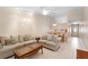 Open living room featuring neutral tile flooring, ceiling fan, and comfortable sofas at 325 Homewood Ave # 10I, Debary, FL 32713