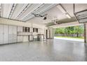 Spacious garage with epoxy floor, ample storage cabinets, laundry area, and open door at 3428 Longleaf Rd, Ormond Beach, FL 32174