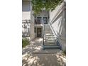 Exterior shot of a condo entrance with stairs leading to the second level and a shaded entry area at 4403 Sea Mist Dr # 2110, New Smyrna Beach, FL 32169