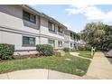 Exterior shot of a condominium showing well maintained landscaping and a walkway to the front door at 4403 Sea Mist Dr # 2110, New Smyrna Beach, FL 32169