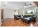 Spacious living room with hardwood floors, a ceiling fan, and large windows for natural light at 502 W Hogle Ave, Deland, FL 32720