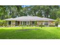 Well-manicured front lawn featuring a single-story home with stone accents and a new roof at 505 Black Ironwood Dr, Deland, FL 32724