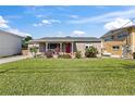 Charming home with a well-manicured lawn and a vibrant red front door at 505 Wisteria Rd, Daytona Beach, FL 32118