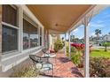 Inviting front porch featuring tiled flooring, plants, and chairs at 505 Wisteria Rd, Daytona Beach, FL 32118