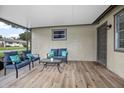 Inviting screened-in porch with comfortable seating, ideal for relaxing and enjoying the outdoors at 5402 Turton Ln, Port Orange, FL 32127