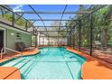 Private screened-in pool area with deck, perfect for outdoor relaxation and entertaining in a serene setting at 552 Hamlet Dr, Port Orange, FL 32127