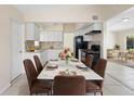 Bright dining area featuring a modern marble table and stylish brown chairs at 5825 Forest Grove Blvd, Orlando, FL 32808