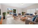 Inviting living room with neutral-toned furniture and sliding glass doors leading to outdoor patio at 5825 Forest Grove Blvd, Orlando, FL 32808