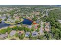 Aerial view of the home nestled in a lush neighborhood with a beautiful lake nearby at 6083 Sabal Hammock Cir, Port Orange, FL 32128