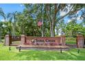 Elegant Sabal Creek community entrance with brick pillars, a wrought iron fence, and manicured landscaping at 6083 Sabal Hammock Cir, Port Orange, FL 32128