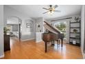 Spacious living room featuring an open floor plan, hardwood floors, and a large window at 613 John Thomas Ave, Deland, FL 32724