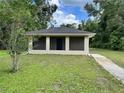 Single story home with neutral toned paint and green lawn and walkway at 632 W Hubbard Ave, Deland, FL 32720