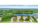 Aerial view of neighborhood homes overlooking a large lake and natural landscape at 762 Onyx Pkwy, Deland, FL 32724