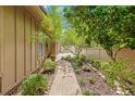 Scenic walkway leading to the house featuring lush landscaping and a variety of plants at 8 Rising Moon Trl, Ormond Beach, FL 32174