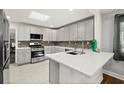 A modern kitchen with quartz countertops, stainless steel appliances, and ample storage at 812 Faulkner St, New Smyrna Beach, FL 32168
