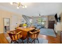 Open-concept living room features hardwood floors, stairs, and natural light at 874 Commonwealth Ct, Casselberry, FL 32707