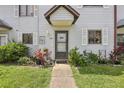 Inviting front entrance with decorative plants and charming details at 903 Deer Springs Rd, Port Orange, FL 32129