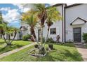 Townhome showcasing a well-maintained lawn and attractive curb appeal at 903 Deer Springs Rd, Port Orange, FL 32129