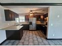 Functional kitchen with stainless steel appliances, dark wood cabinets and breakfast bar at 922 Saxon Blvd, Deltona, FL 32725