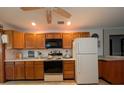 Traditional kitchen with wooden cabinets, standard appliances, and ample counter space at 942 Lemon Bluff Rd, Osteen, FL 32764