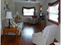 Cozy living room with hardwood floors, plush seating, and windows offering natural light at 942 Lemon Bluff Rd, Osteen, FL 32764