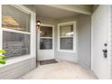 Well-lit entryway features a covered porch, door, and window at 961 S Lakewood Ter # C, Port Orange, FL 32127