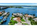 Waterfront homes with private docks on a canal leading to a large bay and distant bridge at 10 Venetian Cir, Port Orange, FL 32127