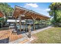 Waterfront dock with boat lift, offering a picturesque setting with lush greenery and a tranquil waterway at 1085 Indigo Rd, Ormond Beach, FL 32174