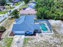 Aerial view showcasing a screened-in pool, spacious yard, and a well-maintained roof at 1104 W Seagate Dr, Deltona, FL 32725