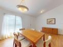 Bright dining room featuring a wooden table with six chairs and a modern light fixture at 1104 W Seagate Dr, Deltona, FL 32725