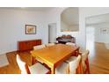 Spacious dining room with wood floors, table for six, and pass through to the living room at 1104 W Seagate Dr, Deltona, FL 32725