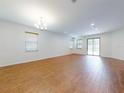 Spacious living room with wood flooring and sliding glass doors leading to the outdoor space at 112 Tuscany Bend St, Daytona Beach, FL 32117