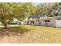 A well-maintained single-story home with a lush green lawn in a peaceful neighborhood at 118 N Sunland Dr, Sanford, FL 32773