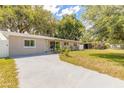Charming single-story home with a well-maintained front yard and a spacious concrete driveway at 118 N Sunland Dr, Sanford, FL 32773