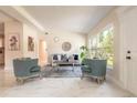 Bright living room featuring sleek marble floors, neutral furniture, and a large sun-filled window at 118 N Sunland Dr, Sanford, FL 32773