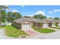 Charming villa featuring a two-car garage and a beautifully paved driveway at 118 Tuscany Villas Dr, Edgewater, FL 32141
